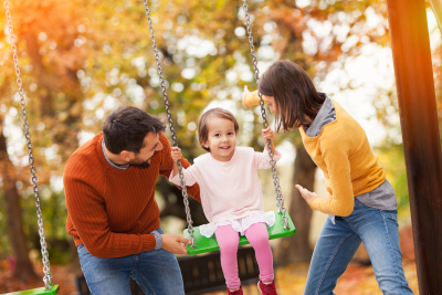 family playing at a park together